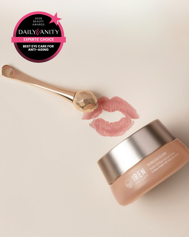 A jar of IREN Shizen TIMELESS ELIXIR Multi-Lift Eye and Lip Cream, a gold facial roller, and a pink lipstick kiss mark with a “Best Eye Care for Anti-Aging” award—ideal for targeting dark circles and signs of aging.
