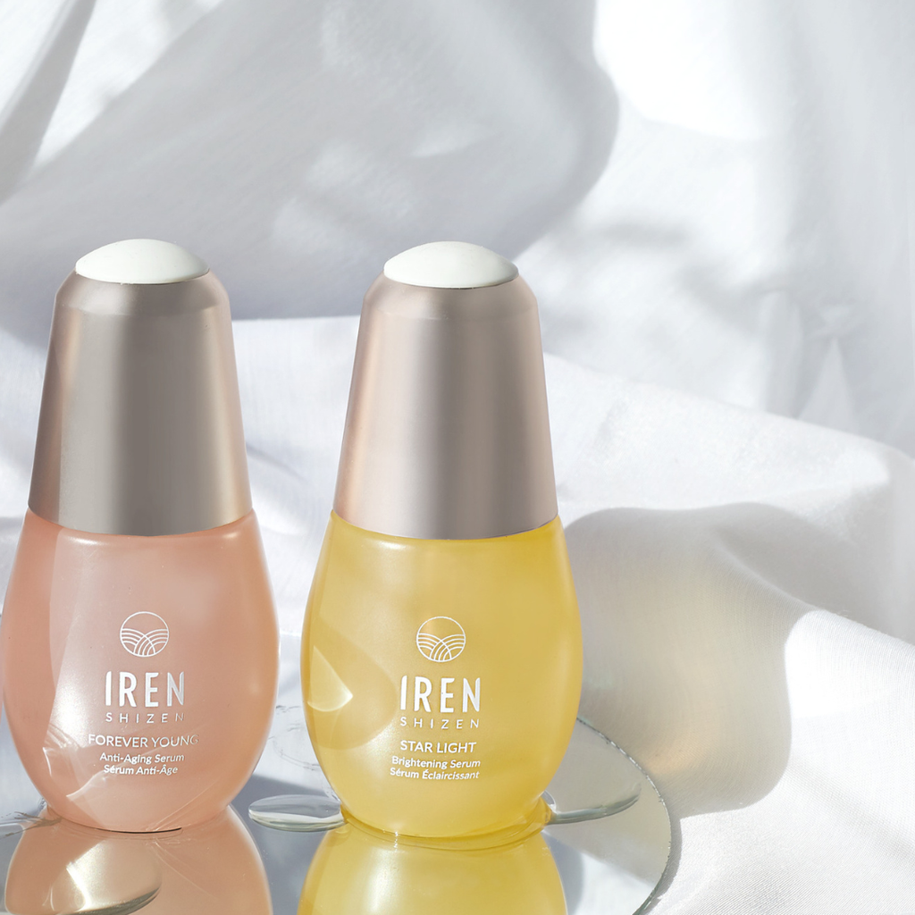 Two bottles of IREN Shizen facial oil, a popular skin care product from the LES ESSENTIELS Best Sellers Set, are displayed on a white surface.