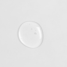 A small drop of custom skincare CLEAR UP Anti-Blemish Discovery Kit by IREN Shizen on a white surface.