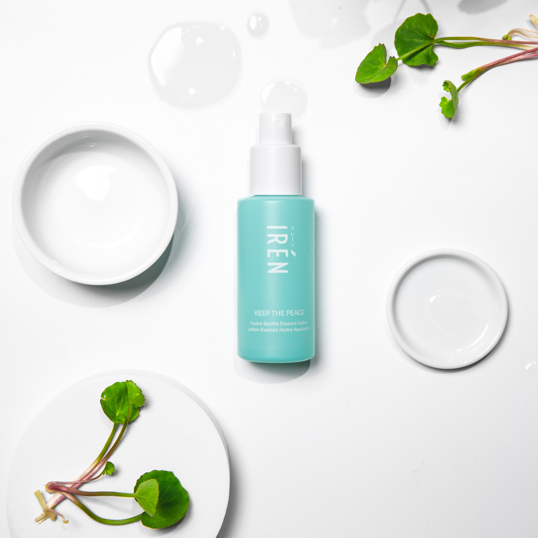 A white plate with a bottle of custom Japanese skincare - KEEP THE PEACE Hydra-Soothe Essence Lotion by IREN Shizen next to it.