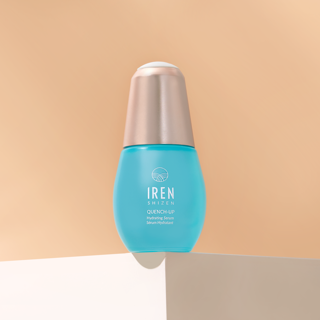 A bottle of Japanese skincare, DEW UP PRO Skin Genie Pro + Hydrating Set by IREN Shizen, sitting on top of a beige background.