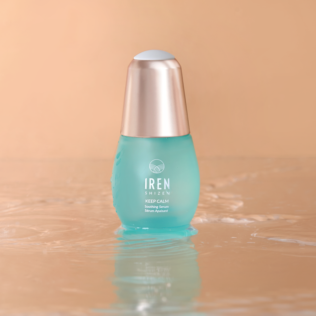 A bottle of customized skincare, the CLEAR UP PRO Skin Genie Pro + Anti-Blemish Set by IREN Shizen, sitting on top of a beige background.